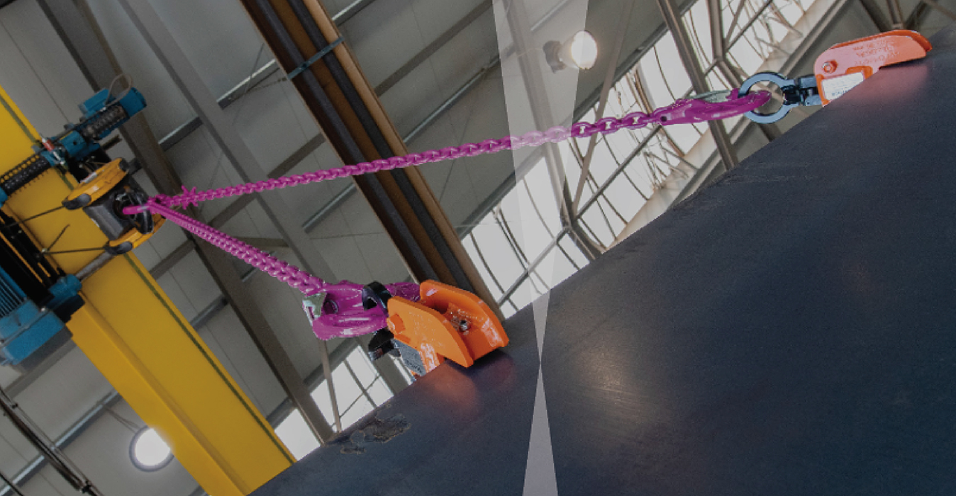 Steel plate lifting clamp securely gripping heavy steel plate